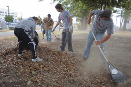 Students work together to do yard work at the Care Center during Campus and Community Day.  - Photo by Morris Abernathy