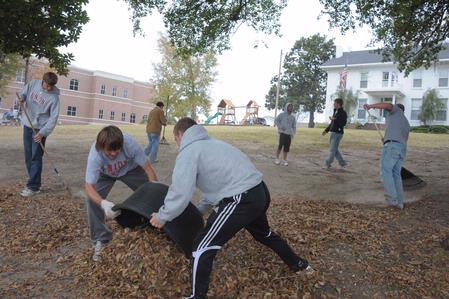 Students do yard work at the Care Center in Jackson, TN, during Campus and Community Day.  - Photo by Morris Abernathy