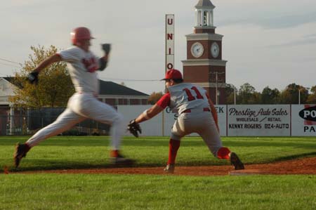 Senior first baseman Josh Allen (11) awaits the throw for a close play at first. - Photo by Steven Aldridge
