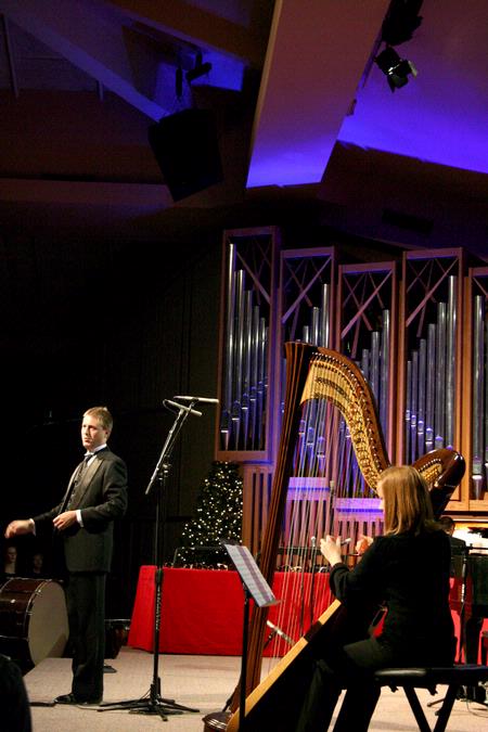Anna Wicker, senior music major, plays the harp while Chris Mathews, associate professor of music and department chair, directs at this year's A Union Christmas program. - Photo by Deanna Santangelo