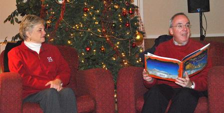 Dr. David S. Dockery, president of the university, reads The Night Before Christmas as his wife, Mrs. Lenise Dockery, joins him in hosting a special time of Christmas memories for Union students.  - Photo by Victoria Stargel