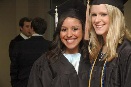 Business administration graduates Kimberly Middleton Sarah Bedwell pose together before receiving their diplomas at West Jackson Baptist Church. - Photo by Beth Spain