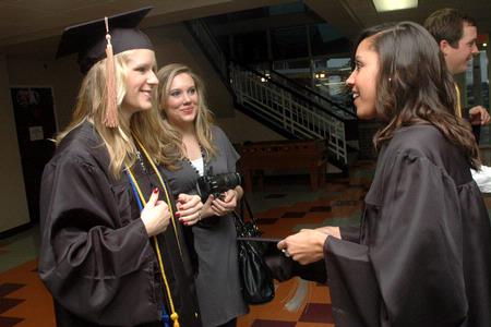 Sarah Bedwel, Amanda Tuzzio, and Kimberly Middleton stand together prior to lining up for graduation at West Jackson Baptist Church. - Photo by Beth Spain