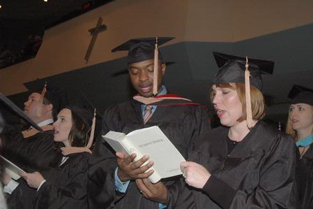 Stacy Miller and Lainey Miller-Ford, both receive their MBA, sing hymns as graduation begins at West Jackson Baptist Church. - Photo by Beth Spain