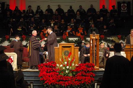 David S. Dockery, president of the university, congratulates students as he hands them their diploma during the 2010 Fall Commencement Services.  - Photo by Beth Spain