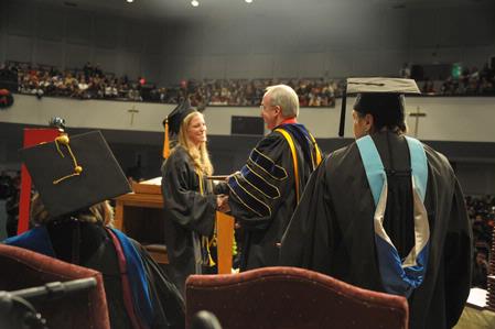 David S. Dockery, president of the university, hands diplomas to the December graduates of Union University. - Photo by Morris Abernathy