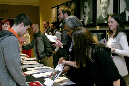 Patricia Porter, transfer enrollment counselor, and Sarah Brooks, enrollment counselor, explain the welcome packet to prospective students during a winter preview day. - Photo by Deanna Santangelo