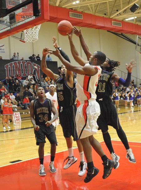 The Bulldogs battle Bethel University for the ball. The Bulldogs won the game by one shot, 77-75.  - Photo by Morris Abernathy