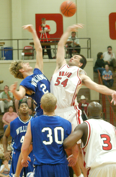 Freshman center Ben Frederick (54) of Bartlett, Tenn. wins the opening tip in his first college basketball game. - Photo by Courtney Ross