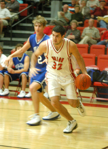 Bruno Martinessi, a junior forward for the Bulldogs, drive to the basket in the season opener versus Williams Baptist. - Photo by Courtney Ross