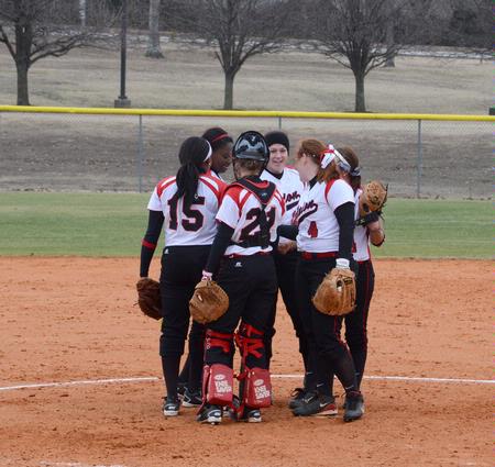 The softball team huddles together before fielding in a game against Christian Brothers University. The Lady Bulldogs won both games in the double header.  - Photo by Victoria Stargel