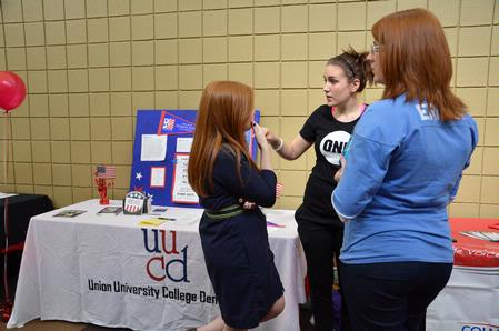 Amer Lovelady, senior political science major, talks with fellow students during the student organization fair about her involvement with ONE, an international mission to fight extreme poverty and preventable disease. - Photo by Abigail Harris