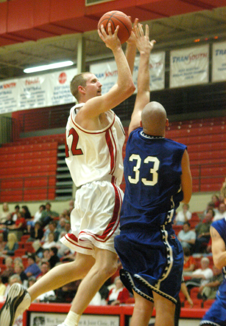 Junior forward Michael Palmer attmepts a shot over a Williams Baptist player in Union's season opener. - Photo by Courtney Ross