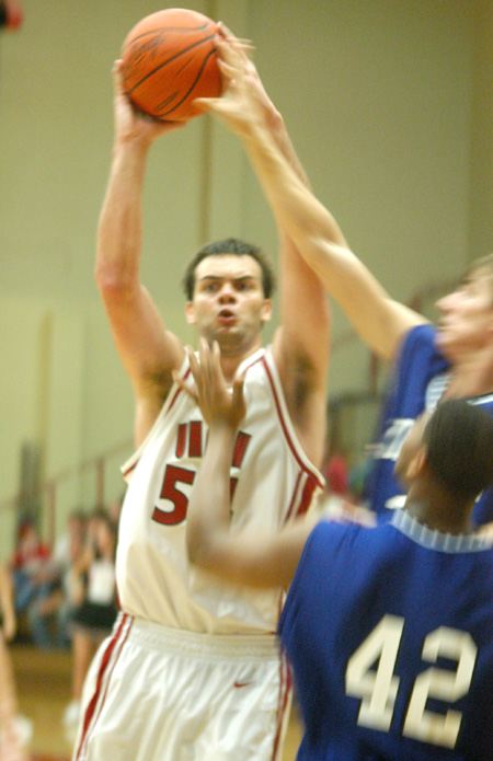 Freshman center, Ben Frederick (54) controls the ball in Union's opening game verus Williams Baptist. - Photo by Courtney Ross
