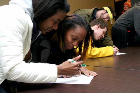 Nar'asha Randall, freshman biology major, and Janay Draper, freshman nursing major, answer a quiz during the first round of events during the Amazing Race for January term students presented by Residence Life. - Photo by Deanna Santangelo