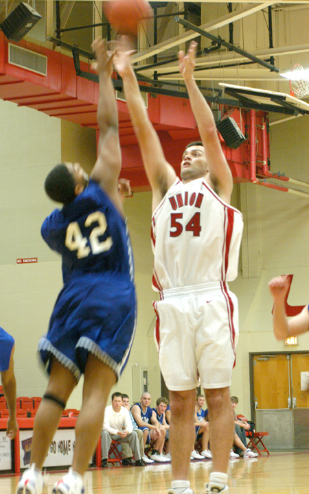 Freshman center, Ben Frederick (54) shoots over a Williams Baptist defender during Union's season opener. - Photo by Courtney Ross