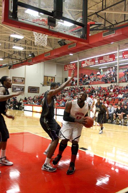 Shane Burrell goes up for a shot against Bethel University defenders. The Bulldogs won the game 77-75. - Photo by Ebbie Davis