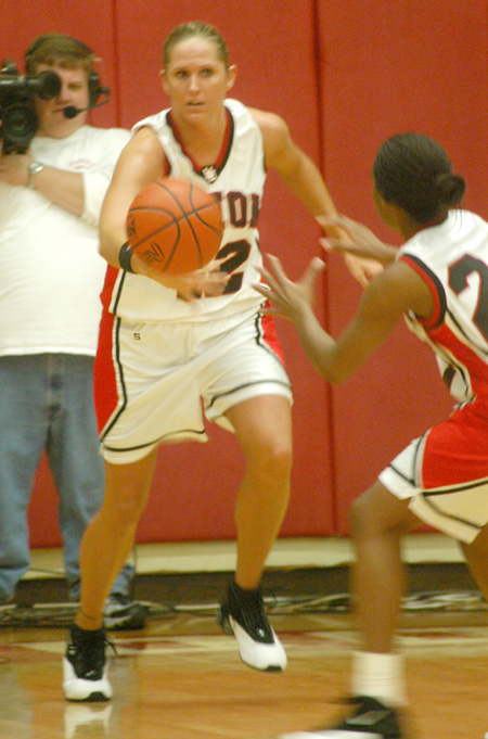 Ginger Bryant (42) gives the ball to teammate Monica Elliot (24) after a rebound. - Photo by Courtney Ross