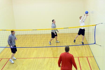 Students play intramural wall ball in the racquetball courts. - Photo by Beth Spain