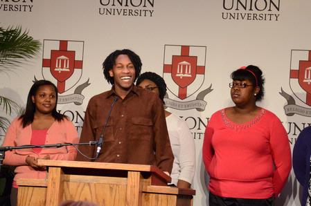 Derique Cannon, sophomore engineering major, leads MOSAIC choir in a song at the 4th Annual Black History Month program. - Photo by Deanna Santangelo