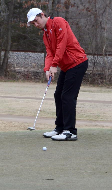 Micah Gentle practices putting at the Jackson National Golf Course. - Photo by Beth Spain