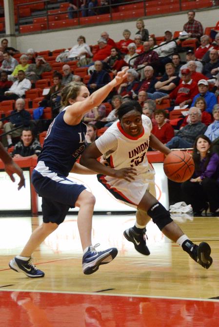 Lady bulldog Lavanda Ross pushes past her Lyon College opponent as she goes for a lay-up. The Lady Bulldogs won the game 65-44. - Photo by Beth Spain