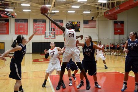 Beatrice Awino Duol grabs a rebound during the game against Lyon College. - Photo by Beth Spain