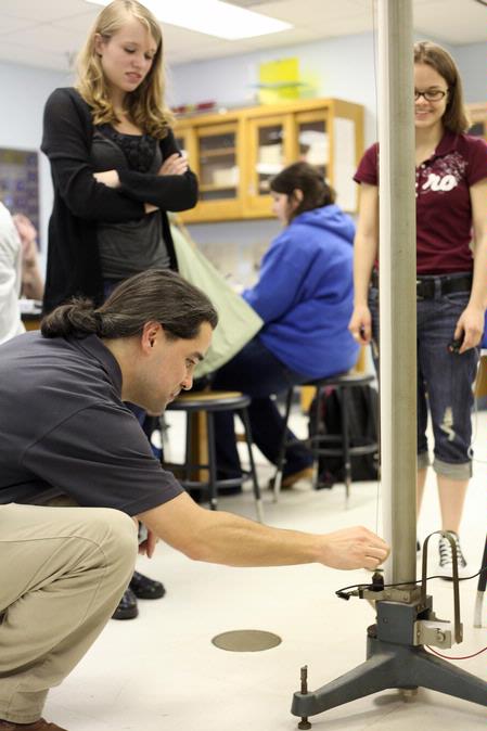 Fonsie Guilaran, associate professor of physics, helps students collect data for their lab experiment on acceleration. - Photo by Kristi McMurry Woody