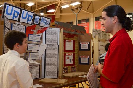 Fonsie Guilaran, associate professor of physics, talks with one of the exhibitors at the West Tennessee Science Fair, which Union University hosted. - Photo by Victoria Stargel