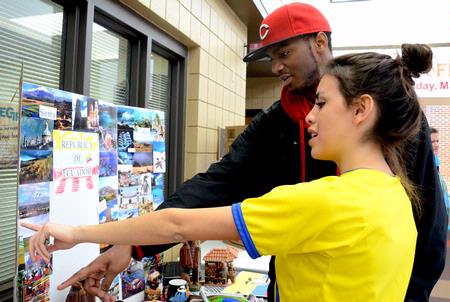 Claudia Velasco, sophomore accounting major, talks about the different scenes that can be found in the Republic of Ecuador to Antoine Hall, freshman computer science major, during the CultureFest 2011 culture fair in the Student Union Building. - Photo by Deanna Santangelo