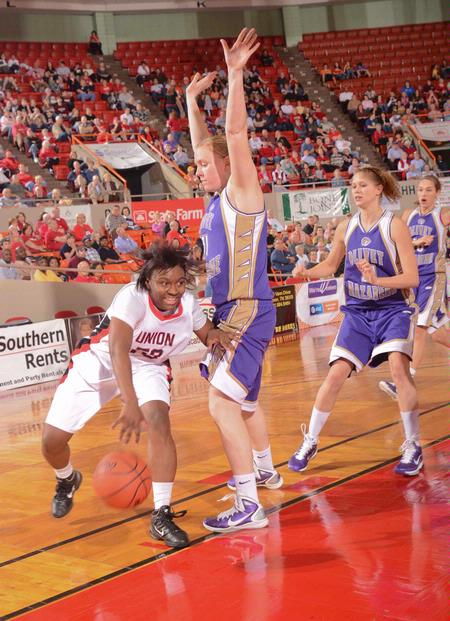 Lavanda Ross goes around her Olivet Nazarene University opponent during game two of the NAIA National Championship. The Lady Bulldogs won 81-69 and advanced to the quarterfinals. - Photo by Morris Abernathy