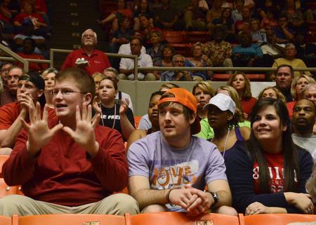 Joe Ball, Union alumnus, Shawn Chandler, senior Biblical languages major, and Abbie Johnson, senior at Trinity Christian Academy, cheer for the Lady Bulldogs during the quarterfinals of the NAIA National Championship. - Photo by Beth Spain