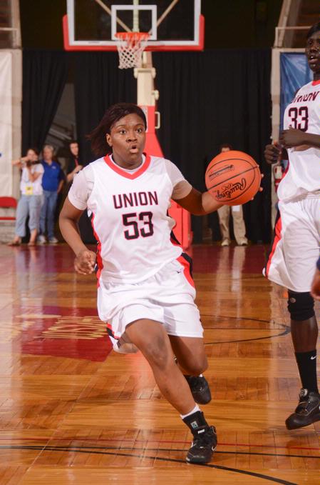 Lavanda Ross moves the ball down the court while calling plays in the semifinals game of the NAIA National Championship. - Photo by Morris Abernathy