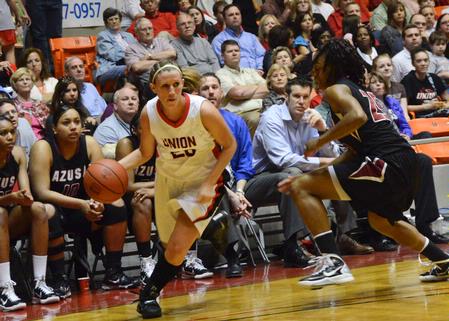 Kayla Hudson drives the ball to the basket against an Azusa Pacific defender. - Photo by Beth Spain