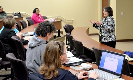 Mary Anne Poe, director of Center for Just and Caring Communities, speaks during the Town & Gown in Providence Hall. - Photo by Deanna Santangelo