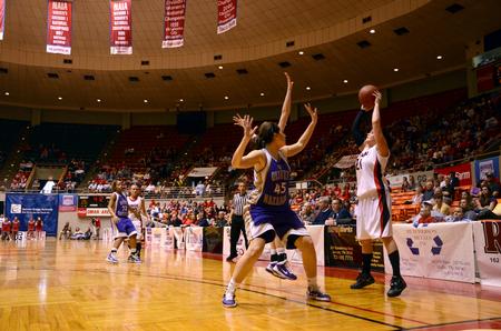 Kayla Bryant looks around for a teammate to pass to during the second round game of the 2011 NAIA Division I Women's Basketball National Championship. - Photo by Ebbie Davis