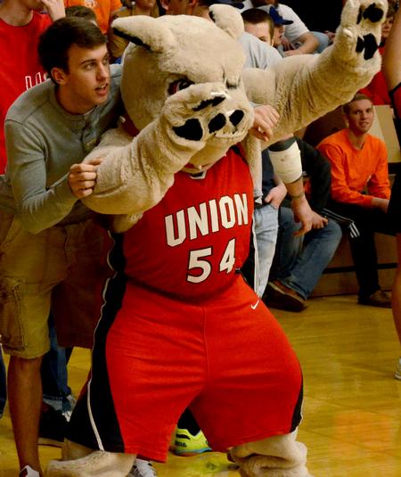 Chase Tuggle, sophomore youth ministry major, joins Buster the Bulldog in cheering for the Lady Bulldogs in a game against Bethel University.  - Photo by Ebbie Davis