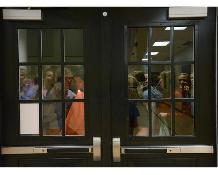 Students wait eagerly outside the Bowld Commons for the Eggstravaganza egg hunt to begin. The event is held in the dark, so students come prepared with flashlights. - Photo by Abigail Harris