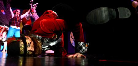 Caroline Beffa, senior art major, break-dances, while the women of Zeta Tau Alpha, preform an original act portraying the circus at the 14th annual Variety Show. - Photo by Ebbie Davis