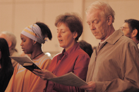 Cindy and Keith Jayne sing carols with junior international student Barbara Nkomazana at <i>A Union Christmas: A Ceremony of Carols</i>. - Photo by Lindsay Stavish