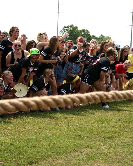 The women of Chi Omega cheer on their sorority sisters during the rope pull competition at Greek Olympics. - Photo by Deanna Santangelo