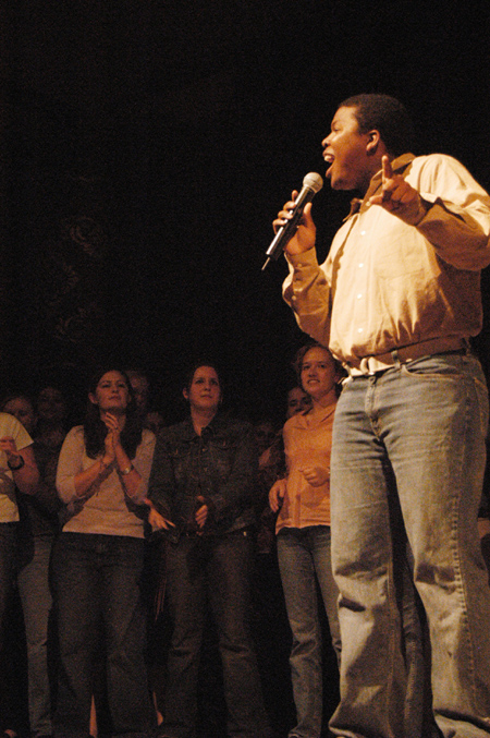 Ray Jones sings a solo as the Gospel Choir backs him up at the SAC Variety Show during Family Weekend 2003. - Photo by Lindsay Stavish