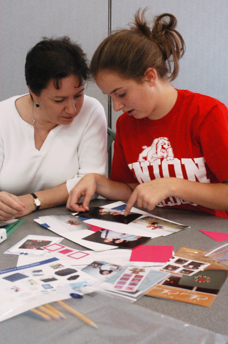 Mallory McHendry's mother Kathy and sister Courtney work on a scrapbook in the Creative Memories Family Workshop during Family Weekend 2003. - Photo by Jonathan Blair