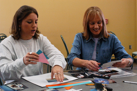 Sophomore Crystal Box and her mother Donna work on a scrapbook in the Creative Memories Family Workshop during Family Weekend 2003. - Photo by Jonathan Blair
