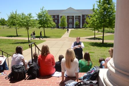 Michael Chute, professor of communication arts, holds his Magazine and Feature Writing class outside on the steps of Jennings Hall. - Photo by Beth Spain