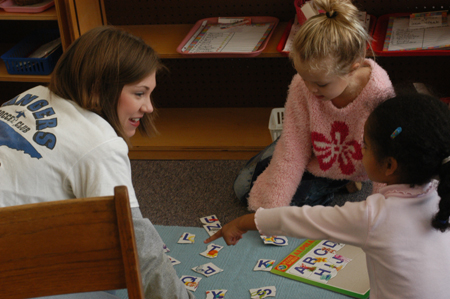 Sophomore Learning Foundations major Jessica Cherry teaches the alphabet to students at Parkview Montessori during Day of Remembrance 2003. - Photo by Jonathan Blair