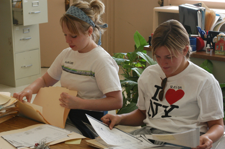 Juniors Jade Barnard and Lori Smith filed papers for a teacher at Parkview Montessori during Day of Remembrance 2003. - Photo by Jonathan Blair