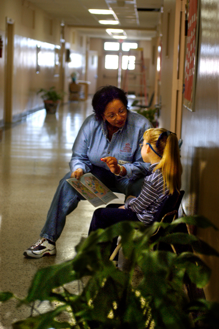 Assitant Professor of Education Camille Searcy  provides some one-on-one reading instruction with a young child at Parkview Montessori during Day of Remembrance 2003. - Photo by Jonathan Blair