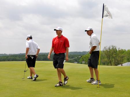 Steven Coffelt (left), Brett Barry and head coach Andy Rushing leave the No. 4 green during the NAIA National Tournament practice round at TPC Deere Run. - Photo by Steven Aldridge