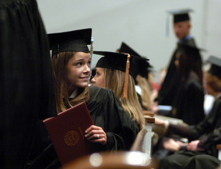 Julie Black, marketing graduate from Cordova, Tenn. scans the crowd for her family during Fall Graduation 2003. - Photo by Justin Veneman